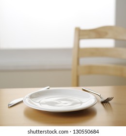 Empty Plate Knife And Fork On The Table