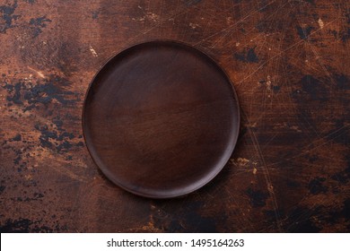 Empty plate and linen napkin on brown wooden background Copy space Top view - Image