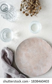 An Empty Plate And A Napkin And Two Water Glasses With A Carafe On A Beige Linen Tablecloth. Top View, Laid Table.
