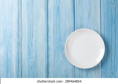 Empty plate on blue wooden background. Top view with copy space - Powered by Shutterstock