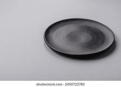 An empty plate on a gray concrete background with copy space. Home dinner cooking - Powered by Shutterstock