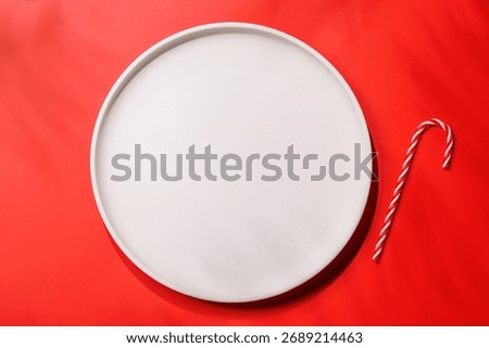 Empty plate on red background, Christmas food mockup. Flat lay