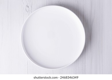 empty plate on white wooden table, top view - Powered by Shutterstock