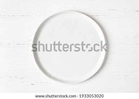 An empty plate on a white wooden table. Top view. ストックフォト © 