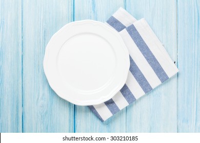 Empty Plate Over Wooden Table Background. View From Above With Copy Space