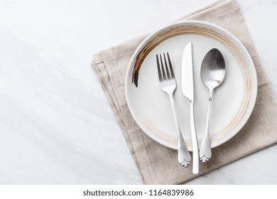 empty plate spoon fork and knife on table