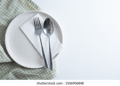 Empty Plate With Spoon And Fork At Napkin 