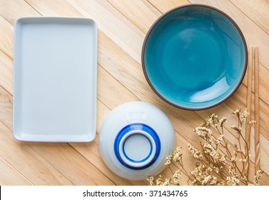 Empty Plate And Sushi Chopsticks On Wood Table