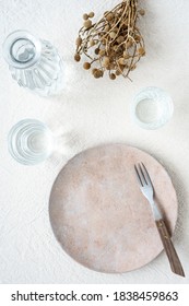 An Empty Plate And Two Water Glasses With A Carafe On A Linen Tablecloth. Top View, Laid Table.