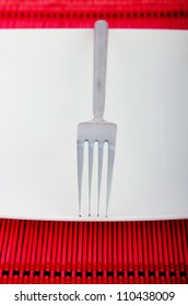 Empty plate with utensils
