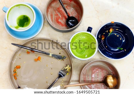 empty plates and cups after eating, waste food after raw healthy breakfast on the table