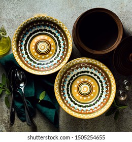 empty plates on a table set for guests. plates and cutlery. dinner or lunch styling