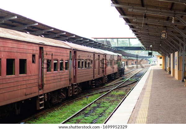 Empty\
platform of a railway station in Sri Lanka. Old rusty train cars.\
It looks like an abandoned place, but it\
not.