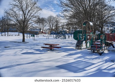 Empty playground covered in snow on a sunny day. - Powered by Shutterstock