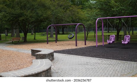 Empty Playground In NY. Tire Swing Spinning With The Wind