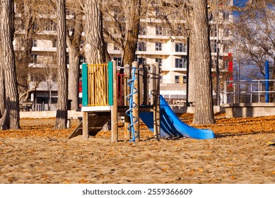 Empty playground on sandy beach in autumn