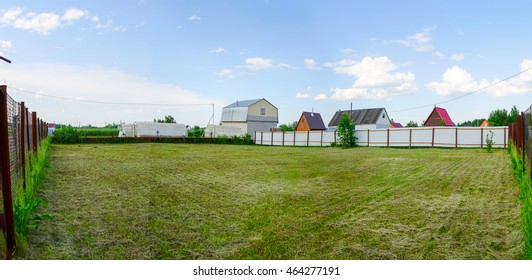 Empty Plot For Sale Behind A Fence In The Village.