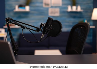 Empty podcast room with professional microphone in vlogger home studio in living. Influencer recording social media content with production microphone, digital web internet streaming station.