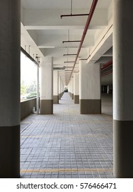 Empty Podium Level Parking Space In Residential Building.