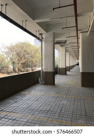 Empty Podium Level Parking Space In Residential Building.