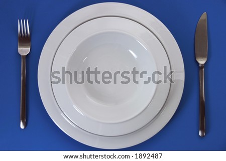 Empty porcelain plates, knife and fork