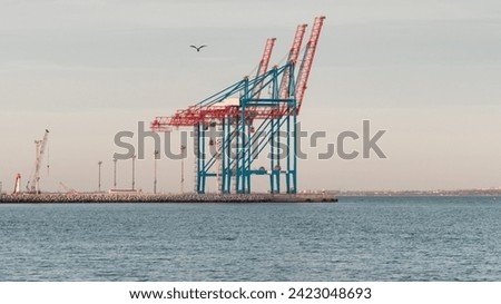 Empty port berth with two gantry cranes. Sunset at empty container terminal - no ships today.  