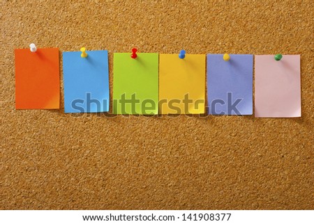 empty post its with pins on memo board