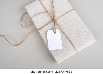 Empty price tag on white fabric, label mockup, folded fabric with tag on white background - Powered by Shutterstock