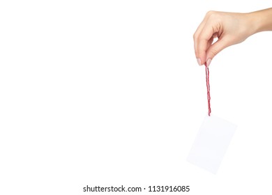 Empty price tag with red string in hand, isolated on white background. copy space template.