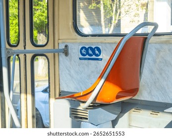 Empty priority seats inside a bus or tram, reserved for pregnant women, elderly people, and disabled individuals, promoting accessibility and inclusivity in public transport