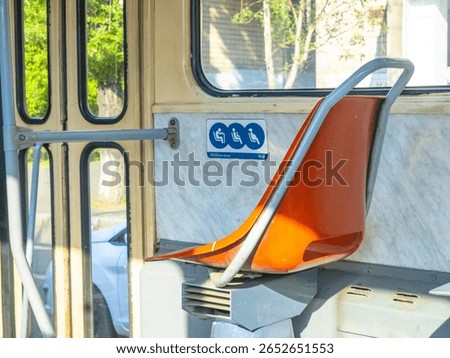 Empty priority seats inside a bus or tram, reserved for pregnant women, elderly people, and disabled individuals, promoting accessibility and inclusivity in public transport