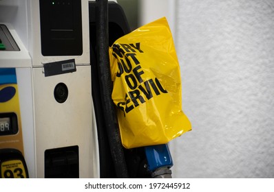 An Empty Pump At A Gas Station Is Covered With A Yellow Plastic Bag Following A Cyber Attack On The Colonial Pipeline. 