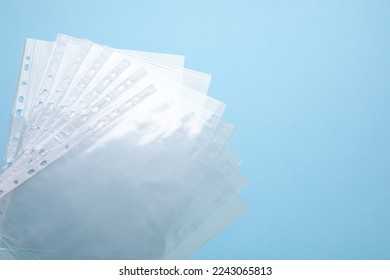 Empty punched pockets on turquoise background, flat lay. Space for text - Powered by Shutterstock