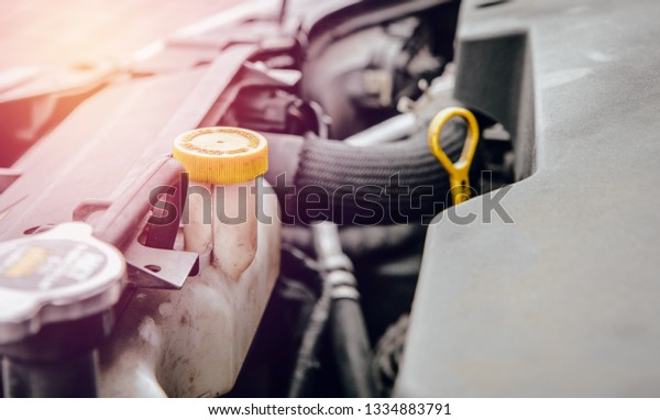 An empty radiator fluid reservoir in the car.\
Concept of problems with car overheating, lack of radiator fluid.\
Incorrect cooling of the car\
engine.