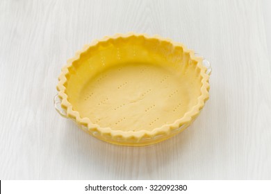 An Empty, Raw, Homemade Pie Crust On A White, Wooden Board Background. Simple, Horizontal, And Plenty Of Room For Text.