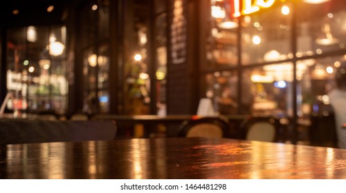 Empty Real Wood Table Top With Light Reflection On Scene At Restaurant, Pub Or Bar At Night. Blurred Background For Product Display Or Montage Your Products With Several Concept Idea And Any Occasion.