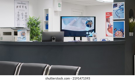 Empty Reception Counter In Medical Clinic To Help Patients With Healthcare Checkup Appointments. Hospital Lobby Desk At Private Facility Center, Waiting Room Area To Treat People With Disease.