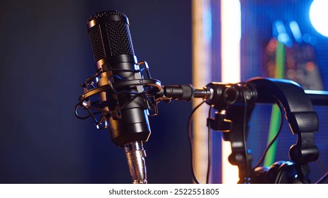 Empty recording studio with a luxury microphone on retro stage, producing musical tunes and acoustic tunes on electronics and modern equipment. Live creative concert. Close up.