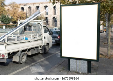 Empty Rectangular Bilboard. Photographed On The Edge. There Is An Iron Profile On The Trucker On The Road.