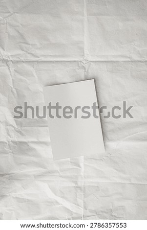 Empty Rectangular Card Template Placed Diagonally over Textured White Paper