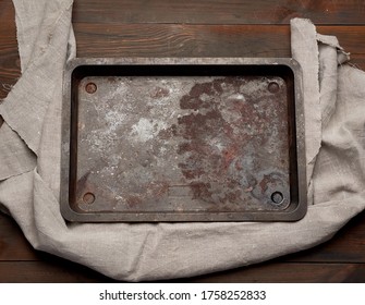 Empty Rectangular Iron Rusty Baking Sheet On A Wooden Brown Table, Top View