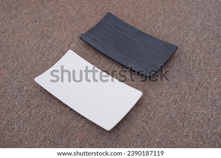 Empty rectangular plate on the ground. Shallow depth of field.