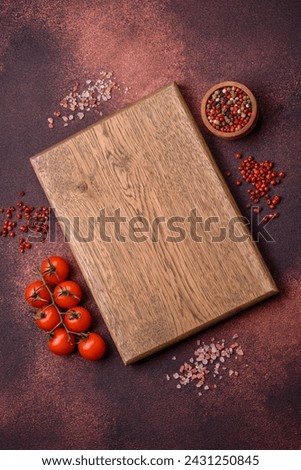 Empty rectangular wooden cutting board on textured concrete background. Cooking at home