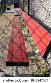 Empty Red Baseball Dugout Bench