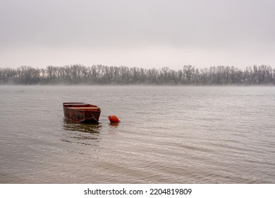 Empty Red Boat In Misty River In Winter