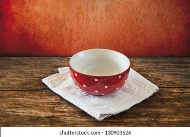 Empty Red Bowl With White Dots On A Table