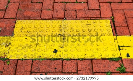 Empty Red Brick Sidewalk Texture with Yellow Tactile Paving for Blind People