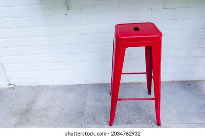 Empty Red Chair With Tall Stool Or Seat For Sitting And White Wall In Outdoor Industrial Style Restaurant Bar