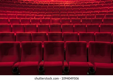 Empty red chairs in the cinema hall