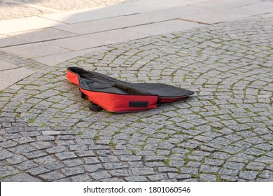 Empty Red Guitar Case Of A Busker In A Pedestrian Zone